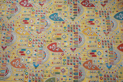 Yellow; embroidered fabric with intricate, colorfull patterns